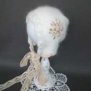 Knitted angora bonnet with embroidery